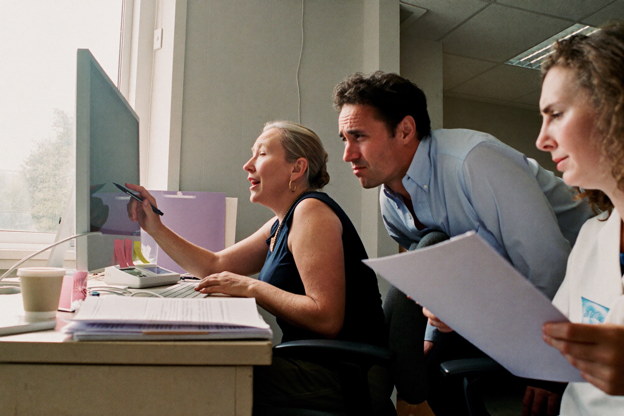 Practice staff working through a claim on screen together at a desk